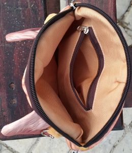 The chain bag has a zippered inside pocket.