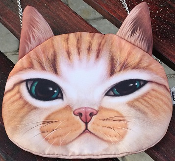 Oliver the Cat Bag, shown here in the chain bag model, can hold a variety of stuff including alcohol and fruit.
